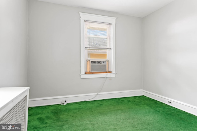 unfurnished room with carpet flooring, cooling unit, and baseboards