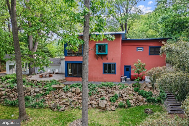 1420 Little Conestoga Rd, Glenmoore, PA 19343 - back of property featuring stucco siding, a fire pit, a patio area, and stairway