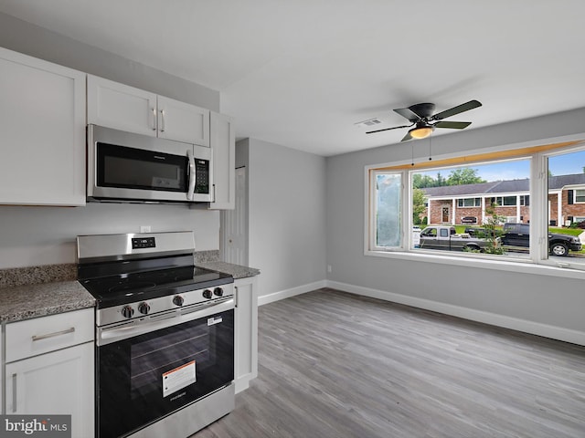 1079 Notley Ct, Pasadena, MD 21122 - kitchen featuring appliances with stainless steel finishes, baseboards, white cabinets, and ceiling fan