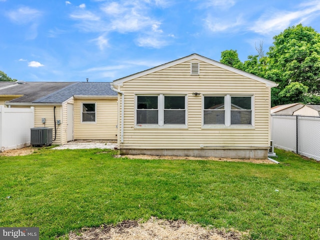 1079 Notley Ct, Pasadena, MD 21122 - rear view of property featuring central AC unit and roof with shingles
