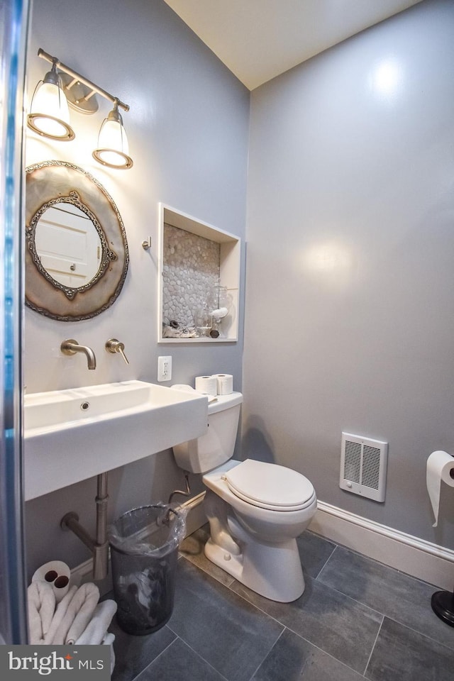 1830 Columbia Rd NW, Washington, DC 20009 - bathroom with heating unit, toilet, baseboards, and tile patterned flooring