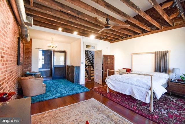 1830 Columbia Rd NW, Washington, DC 20009 - bedroom with wood finished floors, brick wall, and a chandelier