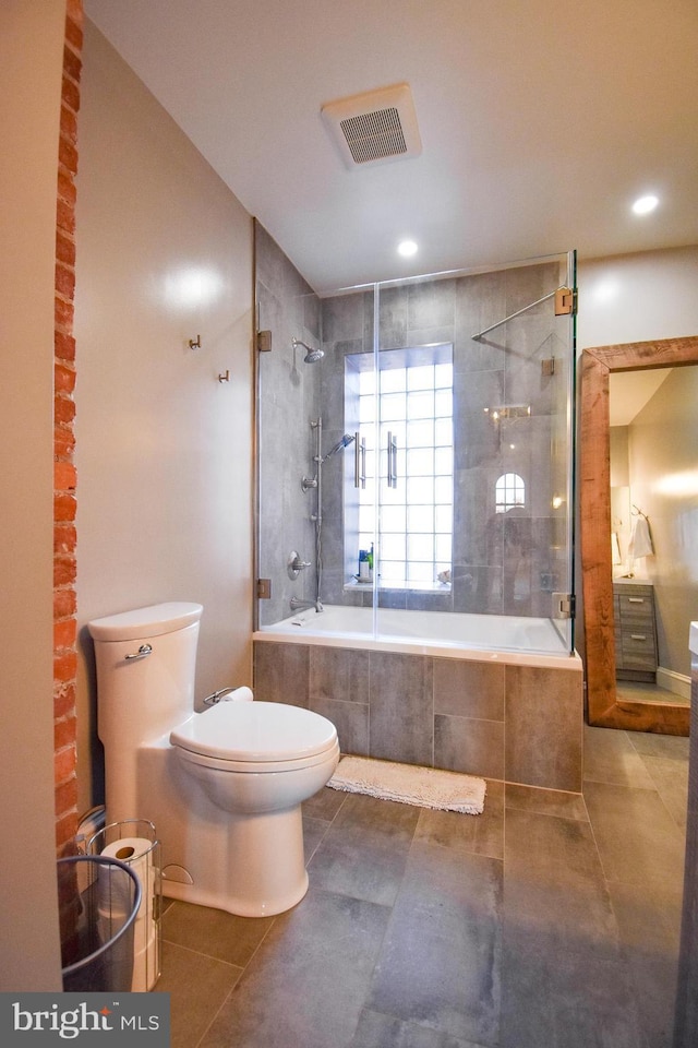 1830 Columbia Rd NW, Washington, DC 20009 - bathroom with tiled shower / bath combo, tile patterned flooring, toilet, and recessed lighting