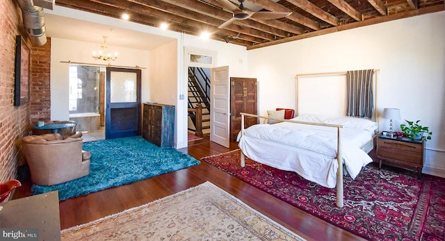 1830 Columbia Rd NW, Washington, DC 20009 - bedroom with brick wall, an inviting chandelier, and wood finished floors