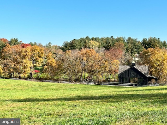 view of yard with a view of trees