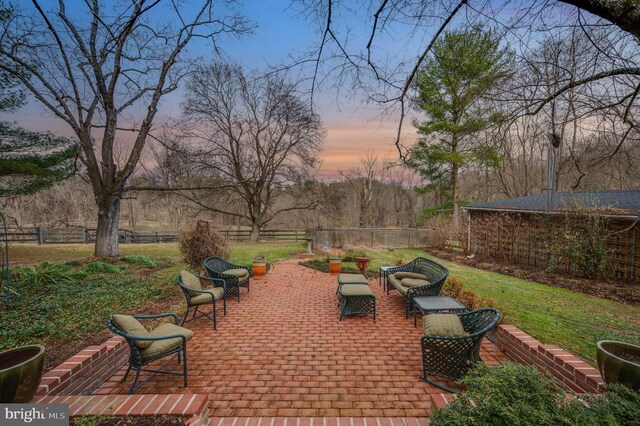 view of patio terrace at dusk
