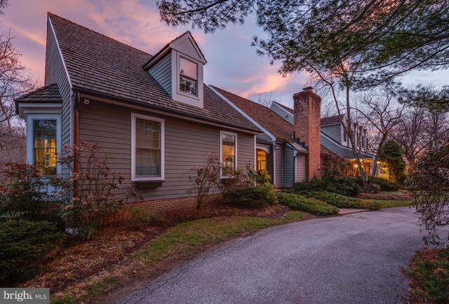 cape cod-style house with a chimney