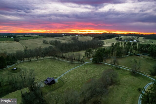 aerial view of property and surrounding area featuring rural landscape
