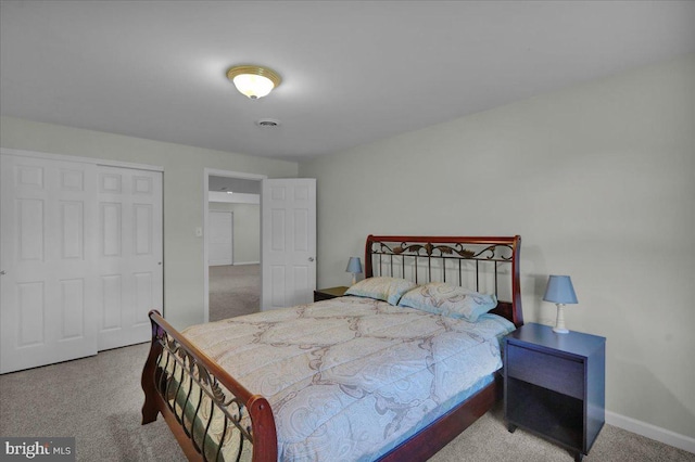 bedroom featuring carpet, baseboards, and a closet