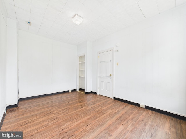 unfurnished room with wood finished floors