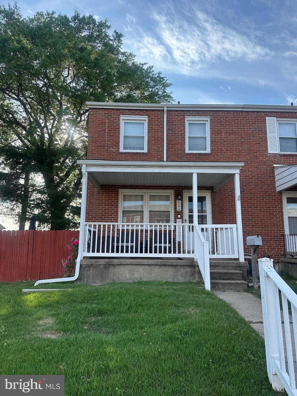 view of front of house featuring brick siding and a porch