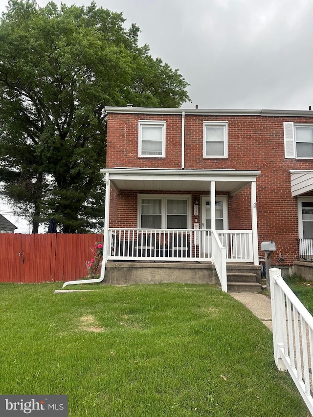 view of front facade featuring brick siding and covered porch