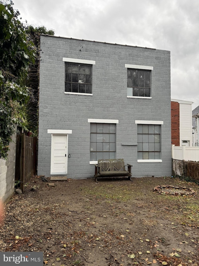 rear view of house featuring fence