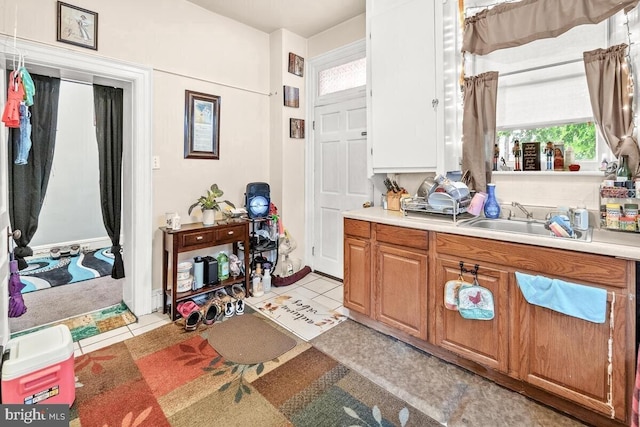 bathroom featuring tile patterned flooring, a healthy amount of sunlight, and vanity
