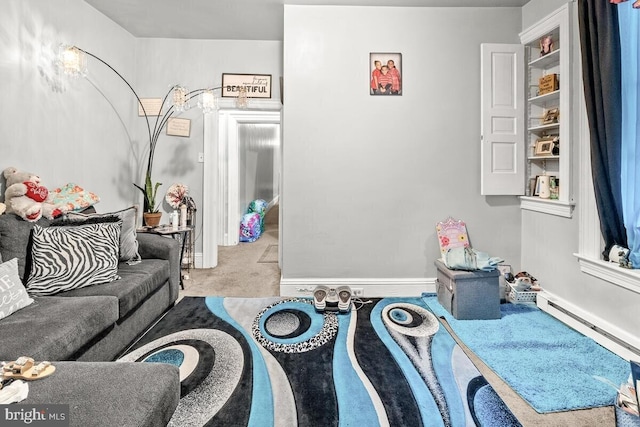 living room featuring a baseboard heating unit and carpet flooring