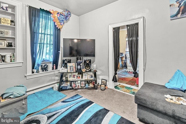 carpeted living area with baseboard heating