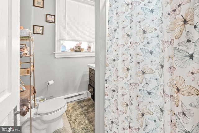 bathroom with vanity, toilet, baseboards, and baseboard heating
