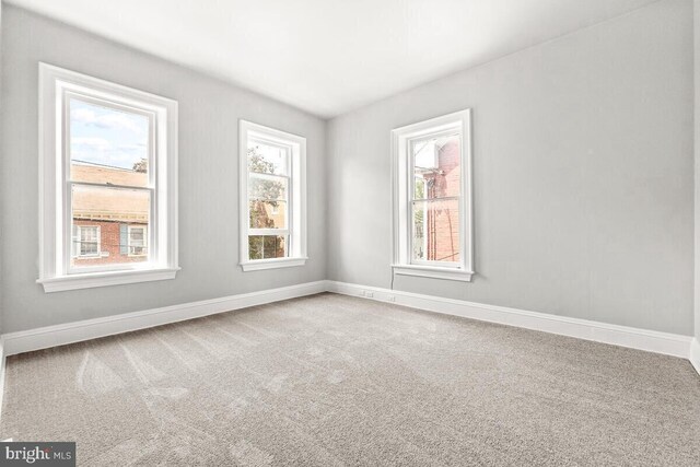 empty room with carpet and baseboards