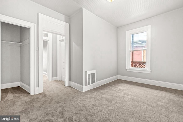 unfurnished bedroom featuring baseboards, a closet, visible vents, and carpet floors
