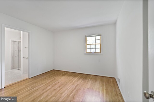 unfurnished bedroom with hardwood / wood-style floors and baseboards