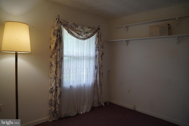 empty room with carpet floors and baseboards