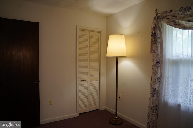 unfurnished bedroom with a closet, baseboards, and carpet floors