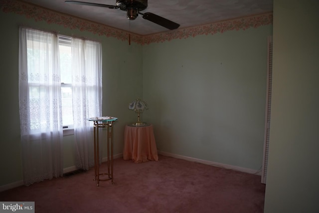 unfurnished room featuring baseboards, light carpet, a healthy amount of sunlight, and ceiling fan