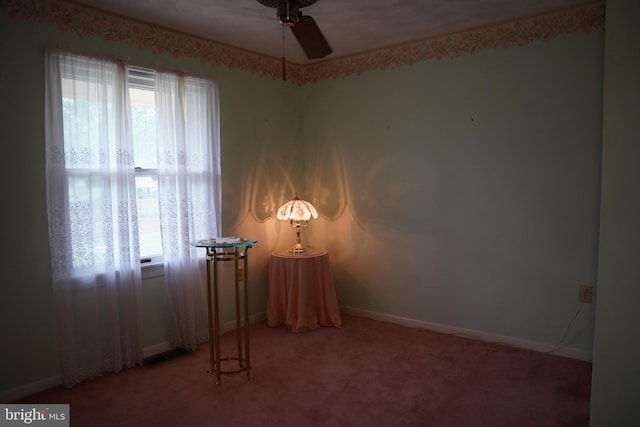 empty room featuring baseboards, ceiling fan, and light colored carpet