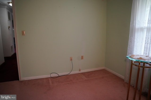 unfurnished room with baseboards and carpet