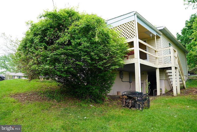rear view of house featuring a lawn