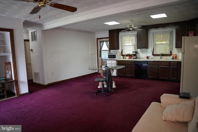 kitchen featuring a sink, dark carpet, crown molding, ceiling fan, and white appliances