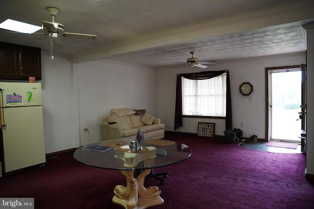 living room with ceiling fan, carpet flooring, and a healthy amount of sunlight