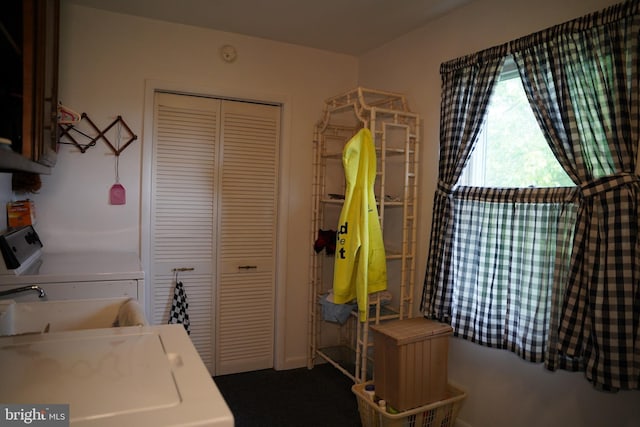 washroom with cabinet space and washer and dryer
