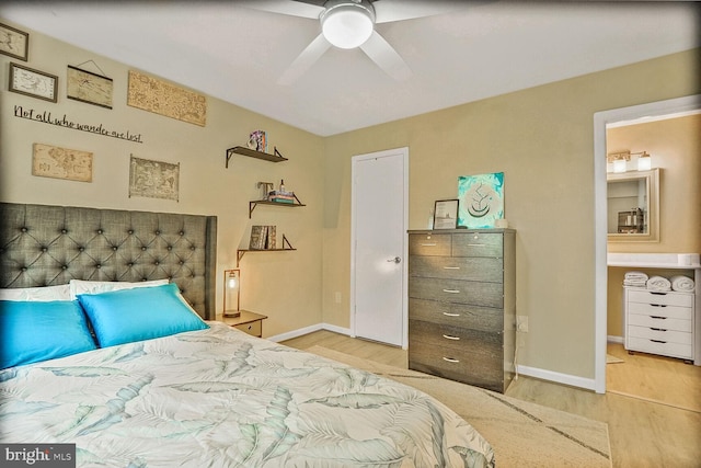 bedroom featuring wood finished floors, baseboards, and ceiling fan