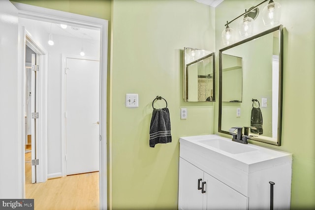 bathroom with vanity and wood finished floors