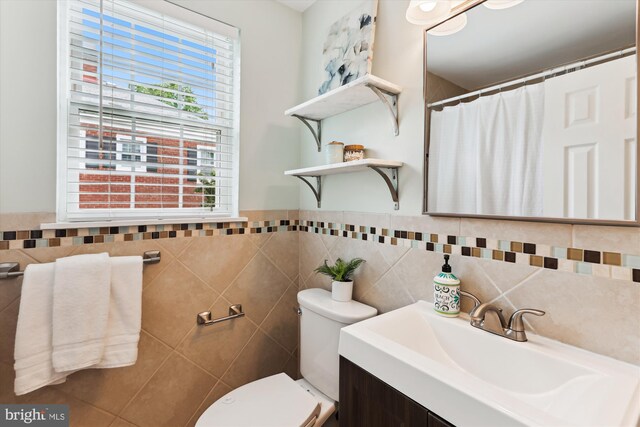 4829 27th Rd S, Arlington, VA 22206 - bathroom featuring tile walls, toilet, plenty of natural light, vanity, and curtained shower