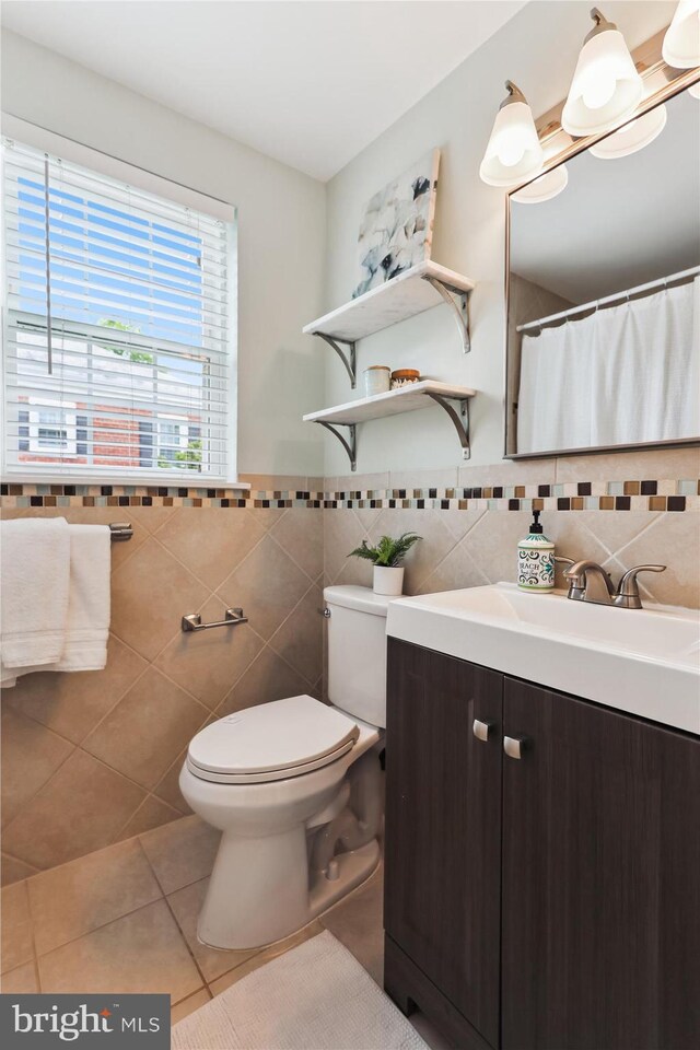 4829 27th Rd S, Arlington, VA 22206 - full bathroom with tile patterned floors, tile walls, toilet, vanity, and wainscoting