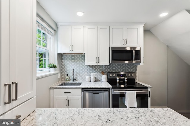 4829 27th Rd S, Arlington, VA 22206 - kitchen featuring appliances with stainless steel finishes, a sink, tasteful backsplash, light stone counters, and white cabinets