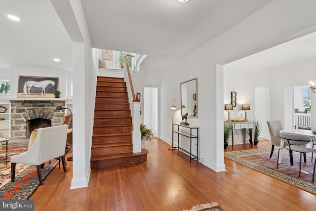 foyer featuring stairway, wood finished floors, healthy amount of natural light, and recessed lighting