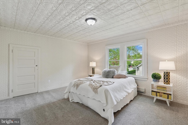 carpeted bedroom with an ornate ceiling