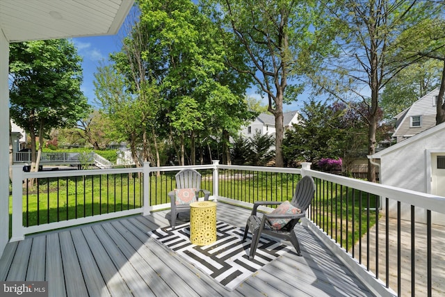 wooden terrace with a lawn