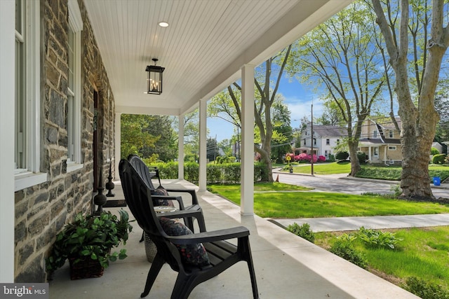 view of patio featuring covered porch and a residential view