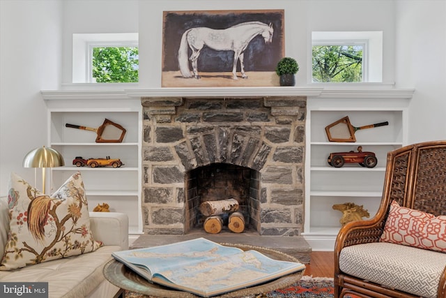 sitting room with wood finished floors and a fireplace