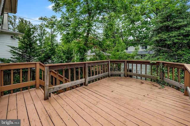 wooden deck with view of scattered trees