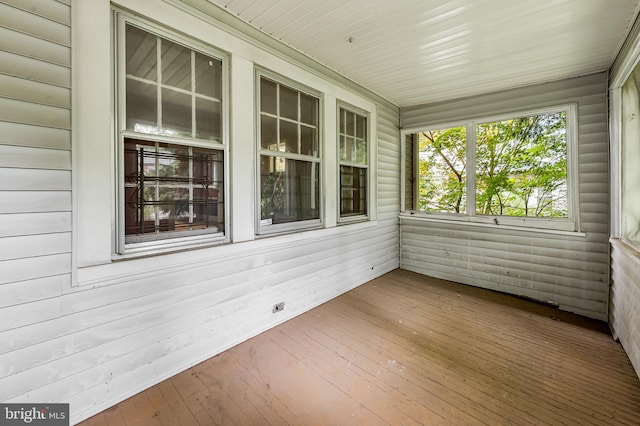unfurnished sunroom with hardwood / wood-style floors