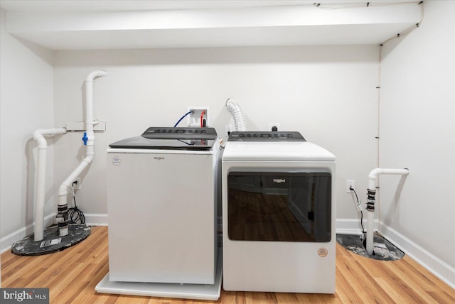 2312 Edmondson Ave, Baltimore, MD 21223 - laundry area with washer and dryer, wood finished floors, and baseboards