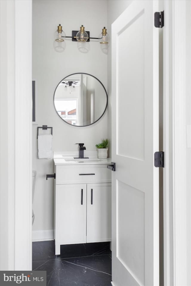 2312 Edmondson Ave, Baltimore, MD 21223 - half bath featuring vanity, marble finish floors, toilet, and baseboards
