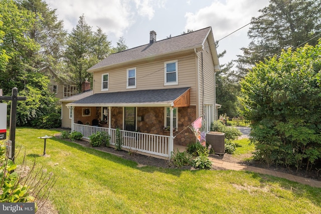 1501 Long Corner Rd, Mount Airy, MD 21771 - view of front of home featuring central AC, a porch, a chimney, a front yard, and stone siding