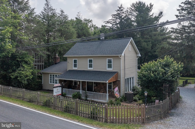 1501 Long Corner Rd, Mount Airy, MD 21771 - view of front of home featuring covered porch, a fenced front yard, central air condition unit, and roof with shingles