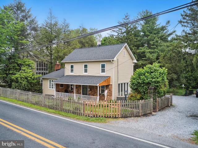 1501 Long Corner Rd, Mount Airy, MD 21771 - view of front of home featuring a fenced front yard, a porch, a chimney, and roof with shingles